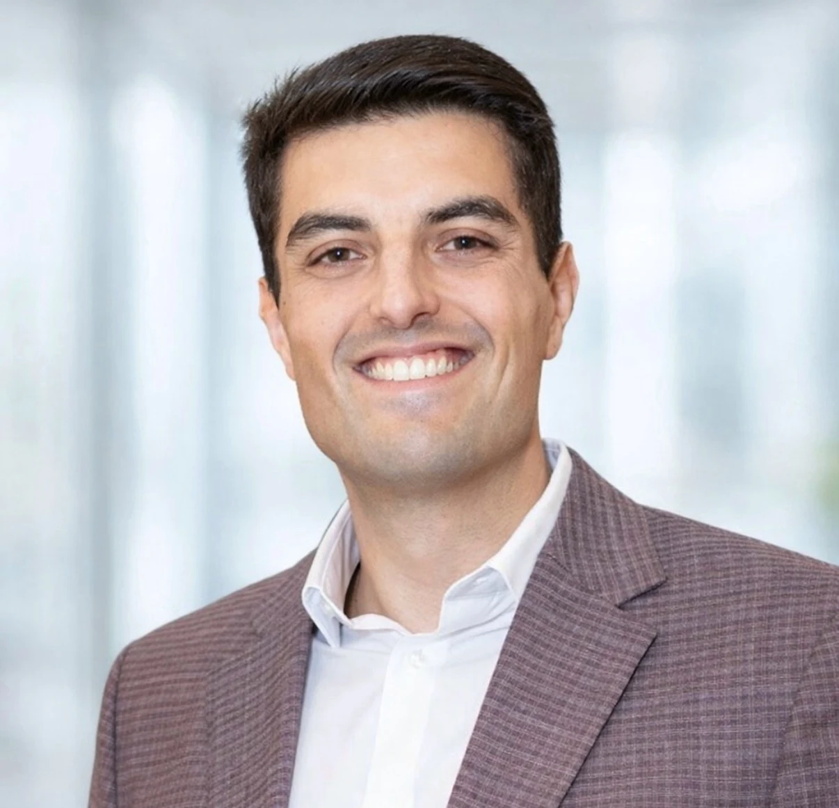 Jad Elahmad smiling in a blazer